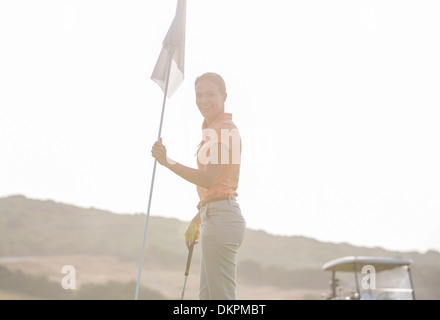 Woman hold golf flag Stock Photo