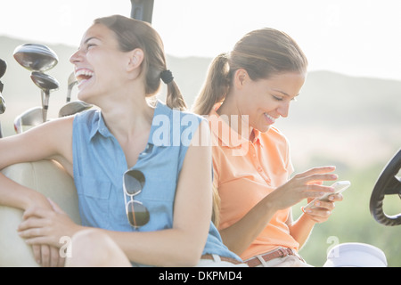 Women sitting in golf cart Stock Photo