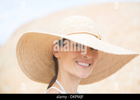 Woman wearing straw hat outdoors Stock Photo