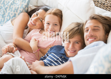 Family relaxing together on sofa Stock Photo