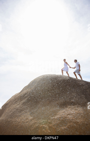 Couple walking on rock formation Stock Photo