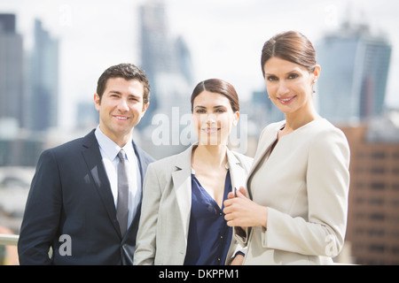 Business people smiling outdoors Stock Photo