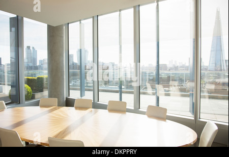 Empty conference room overlooking city Stock Photo