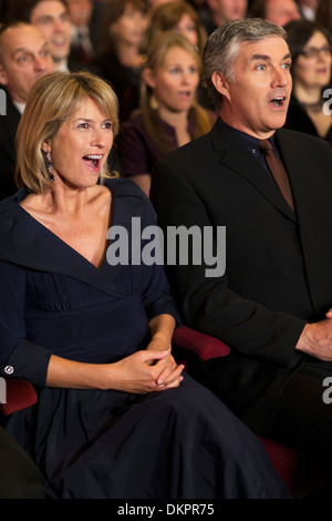 Surprised couple in theater audience Stock Photo