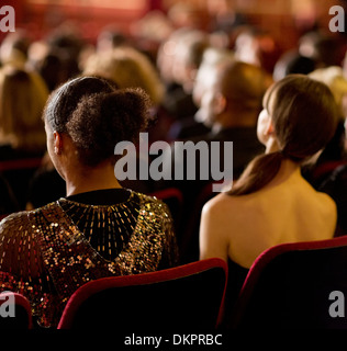Rear view of women sitting in theater audience Stock Photo