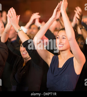 Enthusiastic women clapping in theater audience Stock Photo