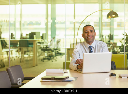 Businessman smiling at desk Stock Photo