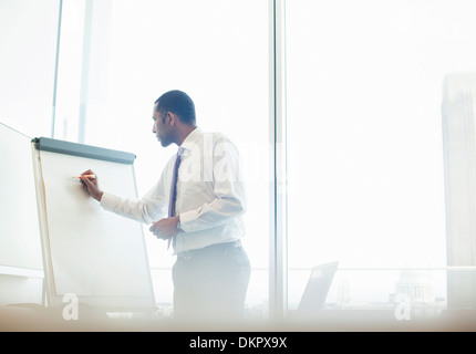 Businessman writing on whiteboard Stock Photo