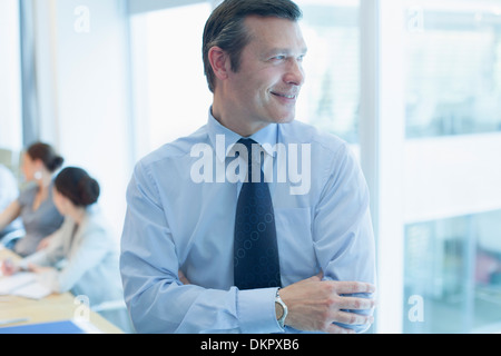 Businessman smiling in office Stock Photo