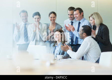 Business people cheering in meeting Stock Photo
