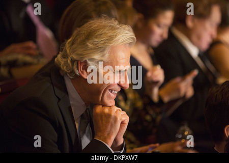 Close up of man laughing in theater audience Stock Photo