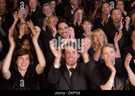 Happy audience clapping in theater Stock Photo