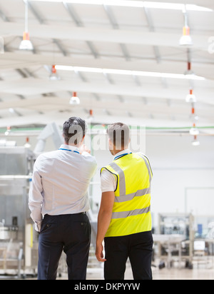 Supervisor and worker talking in warehouse Stock Photo