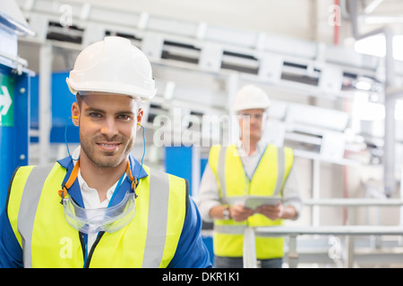 Workers smiling in factory Stock Photo