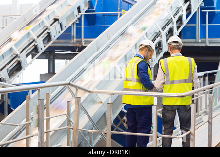 Workers talking in recycling center Stock Photo