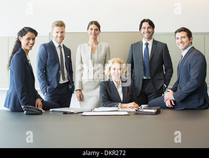 Business people smiling in conference room Stock Photo