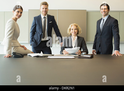 Business people smiling in meeting Stock Photo