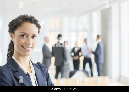 Businesswoman smiling in meeting Stock Photo