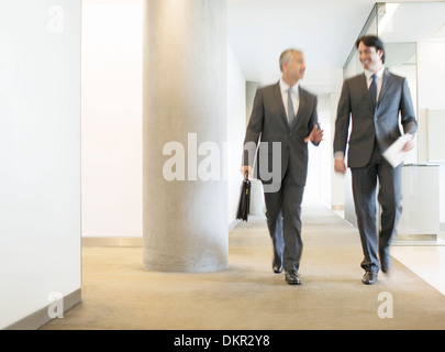 Businessmen talking in office corridor Stock Photo