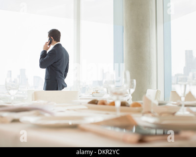 Businessman talking on cell phone in restaurant Stock Photo