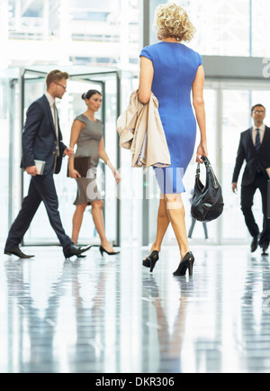 Business people walking in office lobby Stock Photo