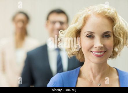 Businesswoman smiling in office Stock Photo
