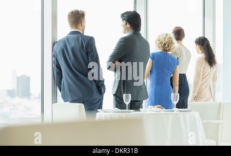 Business people looking out window in restaurant