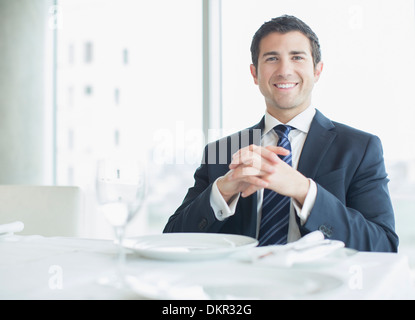 Businessman smiling in restaurant Stock Photo