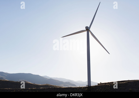 Silhouette of wind turbine in rural landscape Stock Photo