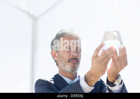 Businessman holding glass of water outdoors Stock Photo