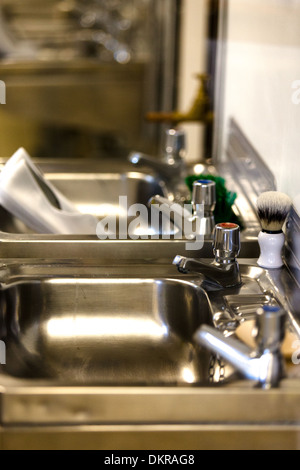 Bathroom sinks taps and shaving brush. Royal Yacht Britannia crew's quarters.Edinburgh Stock Photo