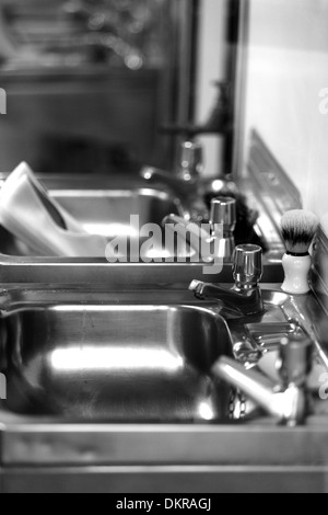 Bathroom sinks taps and shaving brush. Royal Yacht Britannia crew's quarters.Edinburgh Stock Photo