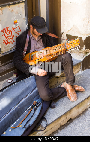 young man playing a nyckelharpa literally keyed fiddle is a traditional instrumentTallinn Estonia Stock Photo