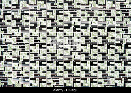 Close up of ceramic tiles in green, black & white in a seventies pattern. Stock Photo
