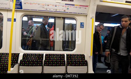 People boarding an empty underground tube carriage at King's Cross London UK   KATHY DEWITT Stock Photo