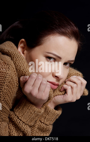 Young woman is having depression. Isolated on black. Stock Photo