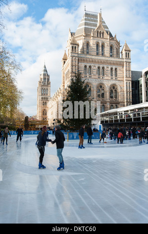 People skating on an ice rink created in the grounds of the Natural History Museum, London, England Stock Photo