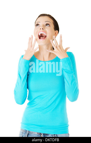 beautiful casual woman screaming, looking up. Isolated on white.  Stock Photo