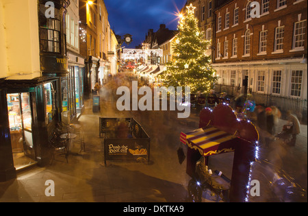 England, Hampshire, Winchester, High street decorated with Christmas tree and decorations, seen from the Buttercross. Stock Photo