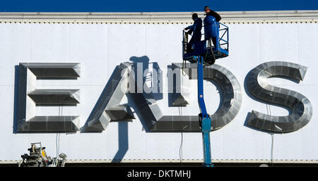 FILE - An archive picture dated 16 January 2012 shows workers installing the letters 'EADS' on a building of the European Aeronautic Defence and Space Company (EADS) at the factory in Ottobrunn near Munich, Germany. EADS intends to present details onthe planned restructuring of the company on 09 December 2013, according to employee representatives. Photo: PETER KNEFFEL/dpa Stock Photo
