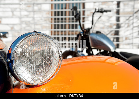 Car detail in the foreground and motorcycle in shallow depth of field Stock Photo