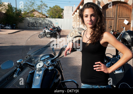 ATHENS, GREECE - OCTOBER 13: Young female stands by parked motorcycles in a Harley Davidson event in Athens on October 13, 2013 Stock Photo