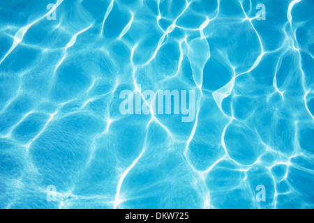 Blue ripped water in swimming pool with sun reflections Stock Photo