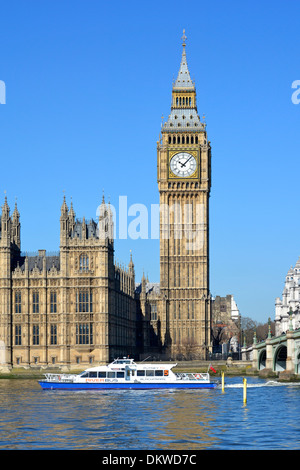 River Thames Putney to Blackfriars River Bus clipper service passing Big Ben clock in the Elizabeth Tower at Houses of Parliament City of Westminster Stock Photo