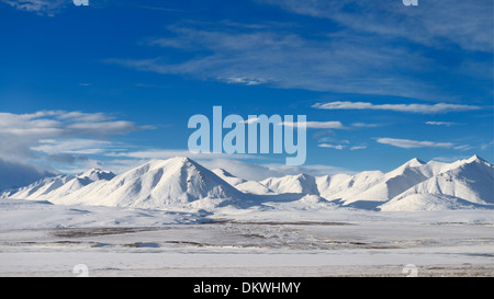 Snow covered Brooks Range mountains Alaska USA with blue sky from the Dalton Highway Stock Photo