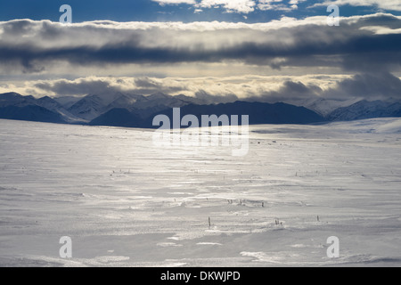 Clouds over the snow covered Brooks Range mountains Alaska USA from the Dalton Highway Stock Photo