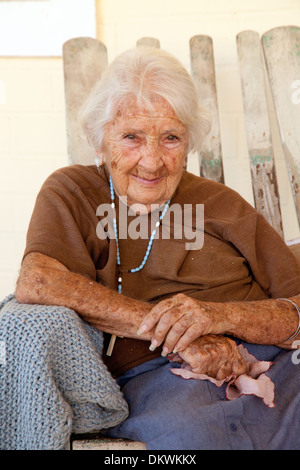 An old Cuban woman, age aged 70s, sitting on her veranda, Vinales town, Cuba caribbean Stock Photo