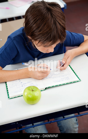 Schoolboy Copying From Cheat Sheet During Examination Stock Photo