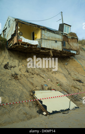 Sea erosion to cliffs at Hemsby Norfolk, England cause bungalow homes to smash into the sea after a tidal surge and gales. Stock Photo