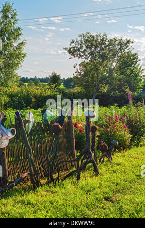 Fence from wooden rods and rural ware hanging on it - 2. Stock Photo